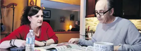  ??  ?? With breakfast over and makeup done, Mike reads the newspaper to Julie in their kitchen, a ritual the couple has had for many years.