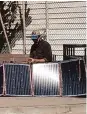  ?? Nora Mishanec/The Chronicle ?? Joseph Adam Moore sets up solar panels at Argonne Playground in San Francisco.