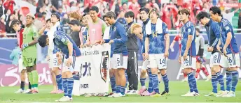  ?? — AFP file photo ?? Japan’s players salute the supporters after the group match against Indonesia.