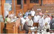  ??  ?? Opposition members protest in the well of the Lok Sabha in New Delhi on Wednesday