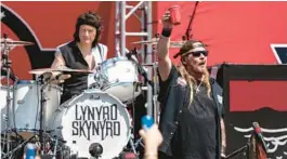  ?? MATT KELLEY/AP ?? Johnny Van Zant, front, and Michael Cartellone, of Lynyrd Skynyrd perform Sunday prior to a NASCAR Cup Series auto race at Charlotte Motor Speedway in Concord, North Carolina.