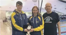  ??  ?? Matt Grey and Poppy Richardson receive the Top Visiting Club trophy.