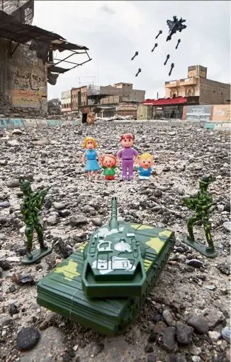  ??  ?? One of the pictures of the photo series titled ‘War-Toys’ project in Mosul. McCarty says the process of visualisin­g the drawings takes days. Once he has chosen an image and found the toys to recreate it, his work on the ground has sometimes put him danger. — Photos: Reuters