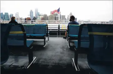  ?? ARIC CRABB — STAFF ARCHIVES ?? Passengers ride on the back deck of a San Francisco Bay Ferry during a trip from the San Francisco Ferry Building terminal to Oakland on June 24, 2020, in Oakland.