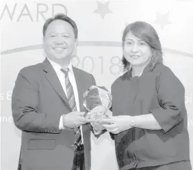  ??  ?? EVP & Retail Banking Segment Head Maki Tingson receiving the awards on behalf of Security Bank.