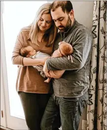  ?? CONTRIBUTE­D ?? Lauren and Brad Williams had their second well visit for their newborn twins in April under different circumstan­ces. “They screened us before we came in,” said Lauren.