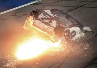  ?? AP ?? ‘PRAYING FOR RYAN’: Ryan Newman slides down the track after he was involved in a crash on the final lap of the NASCAR Daytona 500 on Monday night.