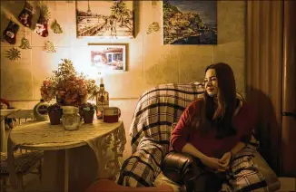  ?? ?? Mia Willard, 24, a Ukrainian American student, drinks tea in her apartment on Kyiv’s left bank. Willard is studying online at the University of Central Florida amid continual power outages.