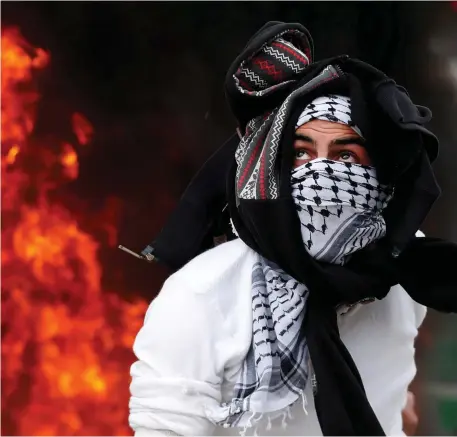  ??  ?? A Palestinia­n protester during a protest against US President Donald Trump’s decision to recognise Jerusalem as the capital of Israel, near Qalandia checkpoint near the West Bank city of Ramallah. Photo: Goran Tomasevic