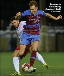  ??  ?? Drogheda’s Ciaran Kelly shakes off David O’Sullivan.