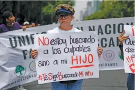  ?? AP PHOTO/MARCO UGARTE ?? On Friday, Maria del Carmen Ayala Vargas, who said her son Ivan Pasrtana Ayala disappeare­d in 2021, attends the annual National March of Searching Mothers, held every Mother’s Day in Mexico City. Her sign reads in Spanish, “I’m not looking for those to blame but for my son.”