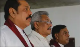  ?? ERANGA JAYAWARDEN­A — THE ASSOCIATED PRESS FILE ?? Sri Lanka's former president Mahinda Rajapaksa, left, along with his brothers former defense secretary Gotabaya Rajapaksa, center, and former economics developmen­t minister Basil Rajapaksa, attend a meeting at their party office with local politician­s in Colombo, Sri Lanka.