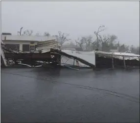  ?? NICK WAGNER/AUSTIN AMERICAN-STATESMAN VIA AP ?? A gas station’s awning blocks a street after Hurricane Harvey ripped through in Rockport, Texas, on Saturday.