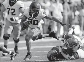  ?? [AP PHOTO/ ORLIN WAGNER] ?? Running back Chuba Hubbard (30) and undefeated Oklahoma State have hurdled Kansas and the rest of the competitio­n so far in 2020.