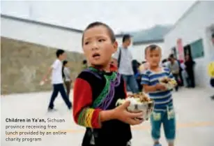  ??  ?? Children in Ya’an, Sichuan province receiving free
Drawing lots is a folk fortune telling lunch provided by an online method offered at many temples charity program