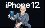  ?? BROOKS KRAFT APPLE INC../AFP VIA GETTY IMAGES ?? Apple CEO Tim Cook holds an iPhone 12 Pro during an event at Apple Park in Cupertino, Calif. The new smartphone comes with new 5G technology, which features faster speeds.