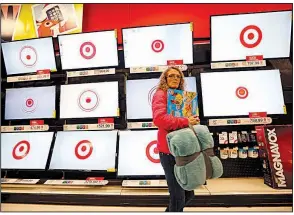  ?? AP file photo ?? A customer shops for flat-screen television­s in a Target store in South Portland, Maine. Despite a drop in third-quarter profits, Target’s chief executive said the retailer is entering the Christmas season with “lots of confidence.”