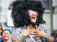  ?? ASHLEY FRASER ?? Thousands of spectators line the streets Sunday as parade marshal China Doll, a popular Ottawa celebrity, enjoys the event.