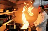  ?? — AFP ?? Oli Khan, the senior vice- president of the Bangladesh Caterers’ Associatio­n, cooks in the Prince of Bengal restaurant in Watford, north of London, on Wednesday.