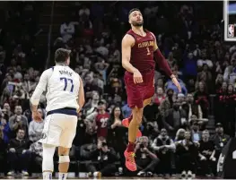  ?? ASSOCIATED PRESS* SUE OGROCKI / ?? Cleveland Cavaliers guard Max Strus watches his59-foot game-winning basket next to Dallas Mavericks guard Luka Doncic at the buzzer in Cleveland on Tuesday.