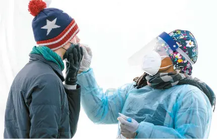  ?? AP-Yonhap ?? A man is swabbed for COVID-19 at a walk-up testing site at Farragut Square in Washington, D.C., on Dec. 23, 2021.