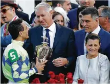  ??  ?? Trainer Todd Pletcher, center, celebrates with jockey John Velazquez and horse owner Vincent Viola after Always Dreaming won the 143rd running of the Kentucky Derby at Churchill Downs.