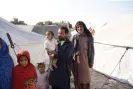  ?? ?? Manzoor Ali, right, with his neighbour at the camp, Badal Chandio, who is holding his son. Photograph: Shah Meer Baloch