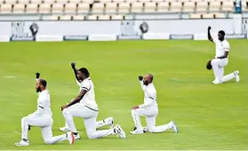  ??  ?? Sending a message: West Indies players take a knee before the start of the first Test