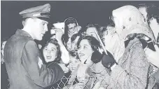  ??  ?? Elvis Presley signs autographs at Prestwick Airport in 1960