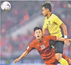  ?? — AFP photo ?? File photo shows Vietnam’s forward Phan Van Duc (left) and Malaysia’s defender Aidil Zafuan fight for the ball during the AFF Suzuki Cup 2018 final football match between Vietnam and Malaysia at the My Dinh Stadium in Hanoi.