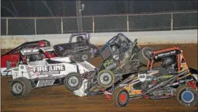  ?? CARL HESS - FOR DIGITAL FIRST MEDIA ?? A spinning Adam Minzer, Jr. (#13) takes a hard hit from Troy Hoffman during the early laps of the “wingless” 270 Micro Sprint main event. Both cars suffered heavy damage and were done for the night. Also involved in the melee was Mike Kalman, in the...