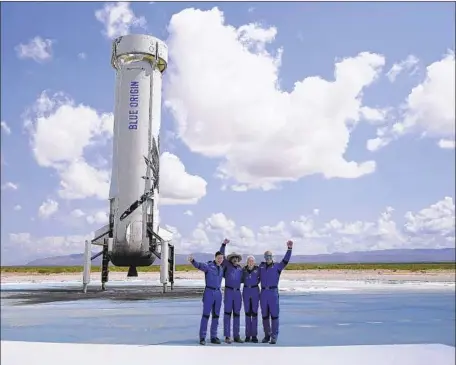  ?? Photograph­s by Tony Gutierrez Associated Press ?? PASSENGERS OLIVER DAEMEN, left, Jeff Bezos, Wally Funk and Mark Bezos pose in front of their rocket after the trip. “Big things start small,” Blue Origin founder Jeff Bezos said. “We’re going to build a road to space so that our kids and their kids can build the future.”