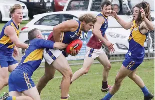  ??  ?? Warragul Industrial­s player Josh O’Brien attempts to break clear of a strong tackle from Ellinbank’s Brett Masterson.