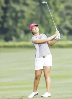  ??  ?? KUALA LUMPUR: Lydia Ko of New Zealand follows her shot on the first hole during the third round of the LPGA golf tournament at Tournament Players Club in Kuala Lumpur, Malaysia, yesterday. — AP