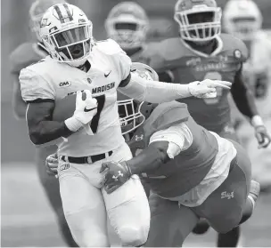  ?? COURTESY OF SAM CRAFT/TEXAS A&M ?? James Madison running back Jawon Hamilton looks to break away from a Sam Houston State defender during Saturday’s FCS semifinal.