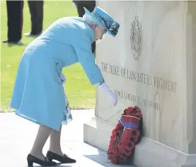  ??  ?? The Queen lays a wreath at the newly unveiled memorial in Staffordsh­ire