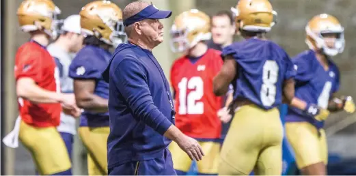  ?? ROBERT FRANKLIN/SOUTH BEND TRIBUNE VIA AP ?? Notre Dame coach Brian Kelly walks on the field during the team’s spring practice in South Bend, Ind., in 2019. The NCAA’s football oversight committee finalized a plan to allow teams to conduct up to 12 unpadded, slow-speed practices during the 14 days before the typical preseason begins in August.