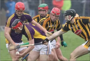  ??  ?? Diarmuid O’Keeffe emerges from a tussle with the ball as Lee Chin offers support.