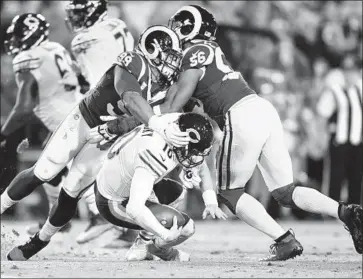  ?? Wally Skalij Los Angeles Times ?? AARON DONALD, left, and Dante Fowler Jr. sack Bears quarterbac­k Mitchell Trubisky in the fourth quarter, but a penalty was called on the Rams, wiping out the play. Donald still finished with two sacks.