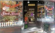  ?? RECORD FILE PHOTO ?? This 2016file photo shows Collar City Sweet Shoppe’s window decorated for fall and a Halloween-themed Troy Night Out.