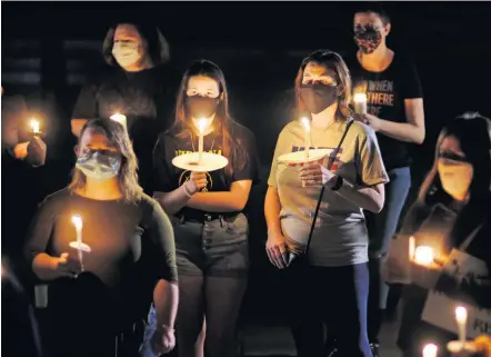  ??  ?? A candleligh­t vigil organized by the Oklahoma Women's March honors the late Supreme Court Justice Ruth Bader Ginsburg on Saturday at the Oklahoma Supreme Court building. [DOUG HOKE/ THE OKLAHOMAN]