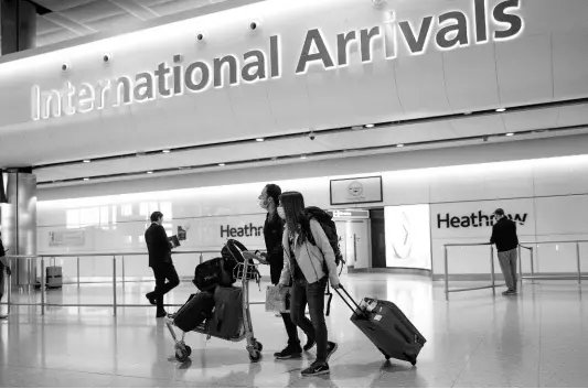  ?? AP ?? In this photo dated June 8, 2020, passengers wearing face masks arrive at London’s Heathrow Airport.