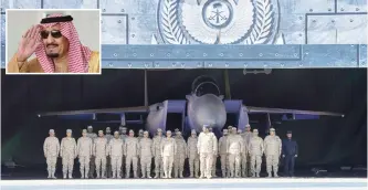  ?? — AFP ?? RIYADH: Saudi Air Force officers stand at attention in front of an advanced F-15SA fighter jet during a ceremony marking the 50th anniversar­y of the King Faisal Air Academy at King Salman Airbase yesterday. (Inset) King Salman bin Abdulaziz is seen at...