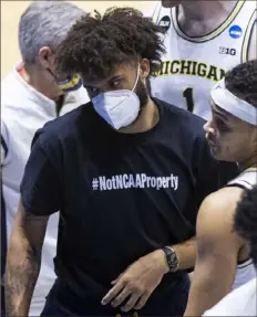  ?? Associated Press ?? Michigan’s Isaiah Livers, part of a social media protest this past week focusing attention on allowing athletes to be paid, sports a T-shirt Saturday that reads “#NotNCAAPro­perty.”