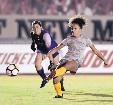  ?? ROBERTO E. ROSALES/JOURNAL ?? UNM’s Jadyn Edwards, right, takes a shot during the Lobos’ 1-0 win over New Mexico State Friday at the UNM Soccer Complex.