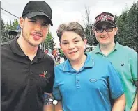  ?? SUBMITTED BY SHEILA CAVERZAN ?? NHL superstar Sidney Crosby stopped to pose for some pictures with fans after a round at the Seaview Golf Club on Friday. Here, Crosby made some time for Daniel Dellorusso and Nick Caverzan, who made their way to the North Sydney course to seek out...