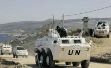  ?? MAHMOUD ZAYYAT/ AFP/GETTY IMAGES ?? UN vehicles patrol the Lebanese-Israeli border on Monday near the village of Ras al-Naqura.