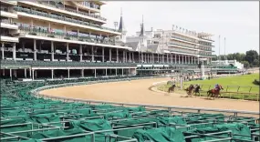  ?? Andy Lyons / Getty Images ?? A general view of empty grandstand­s as horses run a race on Friday’s undercard of Kentucky Oaks day at Churchill Downs in Louisville, Ky.