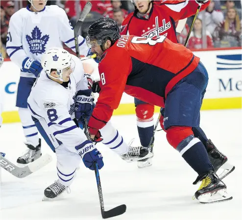  ?? NICK WASS / THE ASSOCIATED PRESS ?? Washington Capitals’ Alex Ovechkin, right, battles against Toronto Maple Leafs defenceman Connor Carrick during NHL action. The top-seed Caps will take on the eighth-seed Leafs in the first round of the East Conference playoffs.