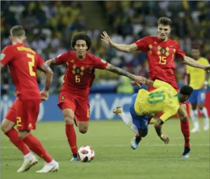  ?? THE ASSOCIATED PRESS ?? Brazil’s Neymar takes a fall while battling Belgium’s Axel Witsel, center, and Thomas Meunier, right, during a World Cup quarterfin­al match Friday.